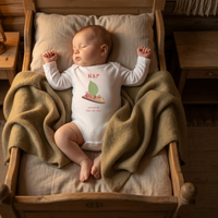 Baby wearing the NAP bodysuit in white (0–6 months) with hand-drawn illustration by Justmimmi