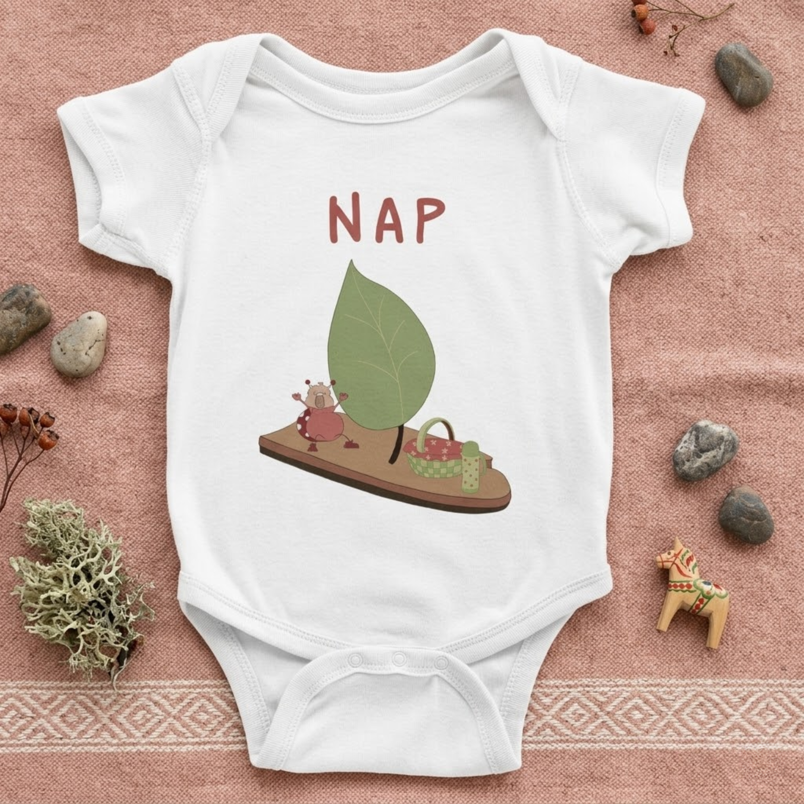 NAP baby bodysuit in white with hand-drawn sleepy character illustration by Justmimmi